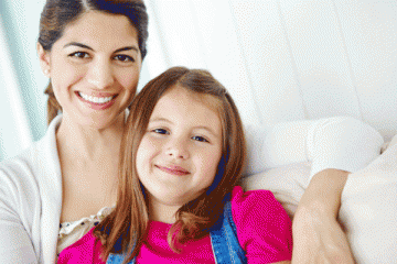 Mom and daughter smiling