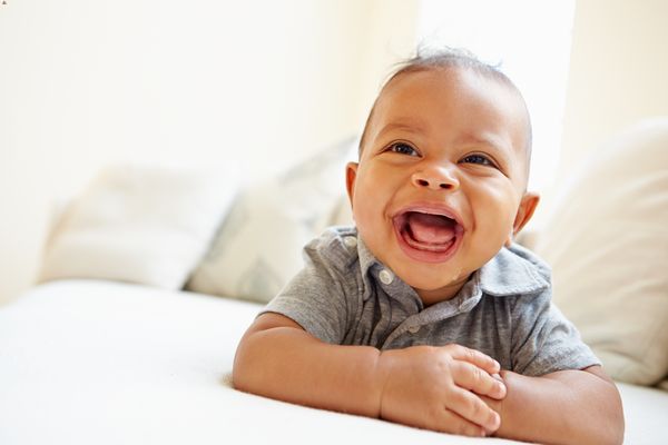 smiling baby boy lying on his stomach